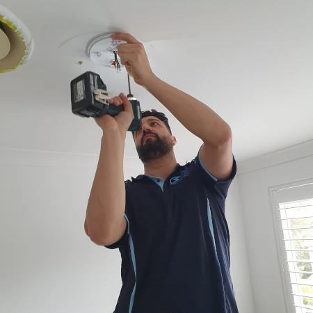 Electrician Preparing LED Ultra Slimline Oyster Light Fixture