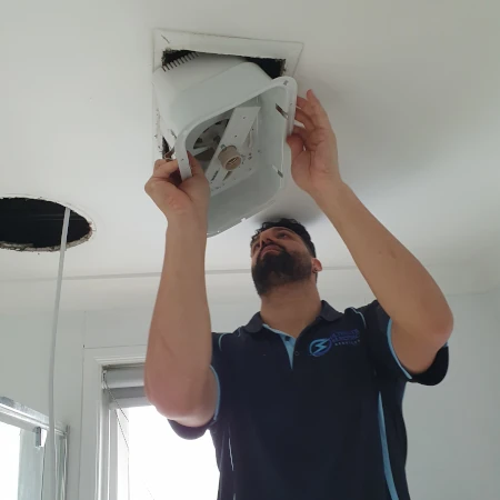 Electrician Installing Bathroom IXL Heater Mounting Base Into Ceiling Space