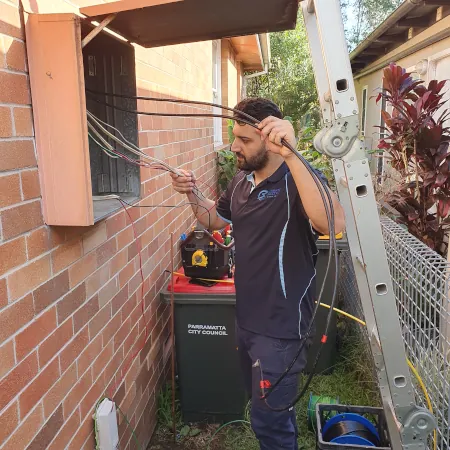 Electrician Examining Switchboard wiring