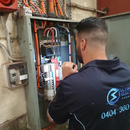 Electrician upgrading a residential switchboard for enhanced safety