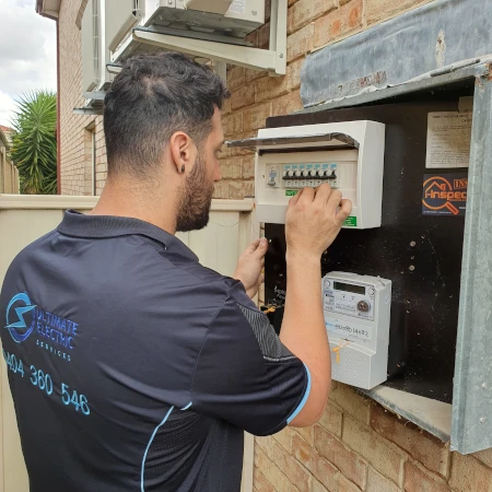 Electrician installing a switchboard surge protector for home appliances